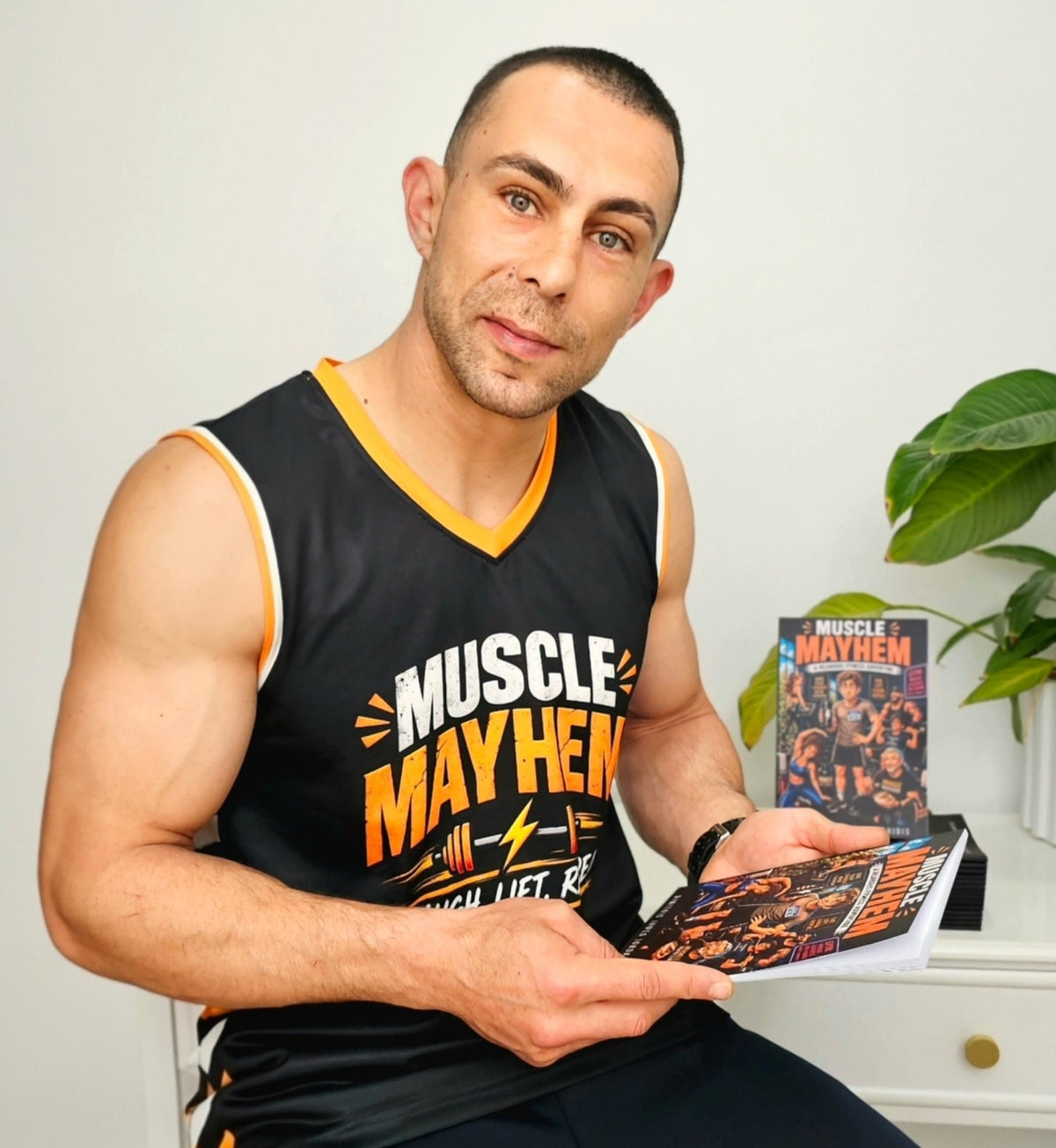 Dimitris James Iordanidis with Muscle Mayhem books in Melbourne